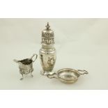 A small Irish silver helmet shaped Cream Jug, by West and Son, Dublin, 1898, chased with birds,