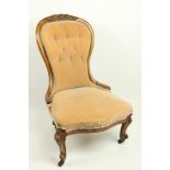 A Victorian Ladies walnut Nursing Chair, with balloon shaped button back, covered in light tan