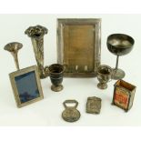 Two silver mounted Photograph Frames, a silver Match Box Holder, a Sterling silver Vesta Case, two