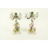 A pair of German porcelain flower encrusted Candelabra, each with four arms on a stem applied with