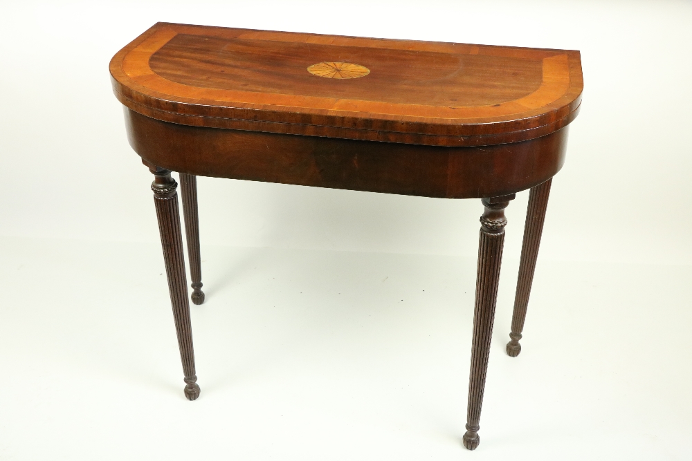 A George IV period mahogany rosewood and satinwood banded fold-over Card Table, the D shaped top