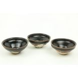 A set of 3 small treacle glazed Chinese stoneware Bowls, 10cms (4"). (3)