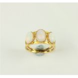 An attractive gold Ring, with three oval moonstones. (1)
