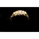 An 18ct gold Ring, with five graduating pearls, set with .1ct of diamond chips, size L 1/2. (1)