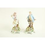 A pair of Sitzendorf porcelain Figures, one modelled as a Lady in pink and yellow floral dress by