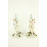 A pair of Dresden porcelain Candlestick Groups, each with classical woman and child forming the