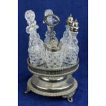 A silver plated rotating Cruet Stand, with six cutglass bottles, some with silver plated mounts. (1)