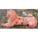 A large terracotta Model of an Egyptian Pharaoh, modelled as a recumbent lion (some damage),