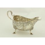 A chased and embossed silver helmet shaped Cream Jug, London 1895 in the Irish 18th Century style,