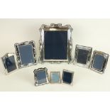 A large cartouche shaped silver mounted Table Photograph Frame, 36cms x 31cms (14" x 12"), six other