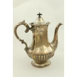 A heavy silver crested Coffee Pot, Sheffield 1914, of baluster form with double leaf scroll