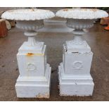 A pair of attractive tall Victorian cast iron Urns on stands, with egg and dart rims outsplayed