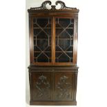 A very attractive Chippendale style carved mahogany Bookcase, the leaf carved and pierced divided