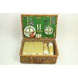 A Sirram Picnic Set, comprising flasks, containers, plates, cutlery etc., housed in a cane work