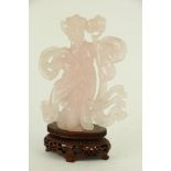 A rare Chinese carved rose quartz Figure of Guan Yin, 18cms (7"), on oval carved and pierced