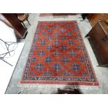 A Dobag Turkish Carpet, the iron red field with rows of blue cruciform medallions inside a