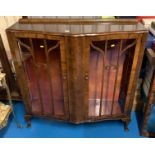 Shaped Walnut china cabinet with Queen Anne legs. 2 glass opening doors and 2 glass shelves. 44”