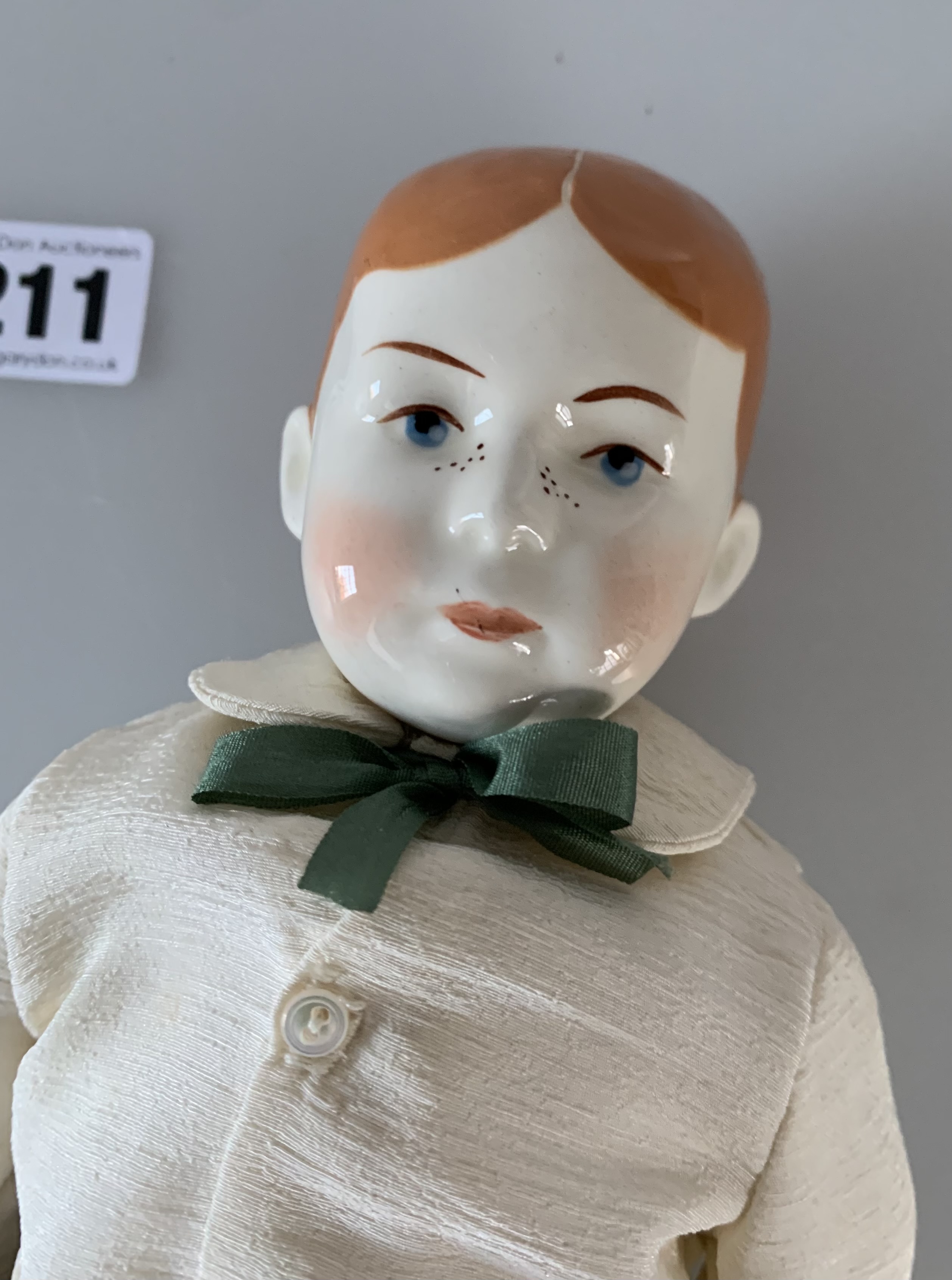 China boy doll dressed in brown velvet trousers, cream shirt, green tie. 13” high - Image 3 of 6