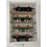 4 Hornby ‘O’ gauge lumber wagons – 2 x black-red bolsters, LMS 1925 olive green-red bolsters and