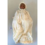 Black (reproduction) Bylo Baby. Dressed in cream silk gown & bonnet with antique lace trim and