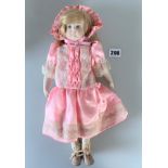 Modern dressed doll in pink dress & bonnet with ceramic head/arms/legs. Painted eyes. Soft body. 14”