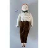 China boy doll dressed in brown velvet trousers, cream shirt, green tie. 13” high
