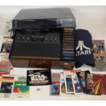 Atari Video Computer System with cover and games, mixed instructions and game manuals including ET