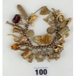 9k gold charm bracelet with heart lock and 31 charms (18 marked 9k, rest unmarked). Total w: 114