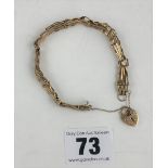 9k gold gate bracelet with heart lock, 8” long. W: 6.6 gms