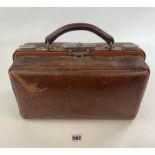 Leather Portmanteau gentleman’s travelling toilet bag with part contents of 2 glass bottles and tin,