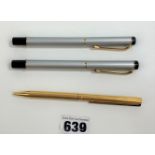 Silver/black fountain pen and matching roller ball pen and gold coloured roller ball pen