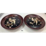 Pair of oriental lacquered wooden plates with applied birds and butterflies in mother of pearl 14”