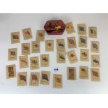 Old Thorntons tin with Kensingtons silk cigarette cards