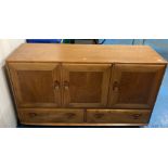Ercol style light wood sideboard with 3 cupboards and 2 drawers. On castors. 51”w x 17”d x 30”h