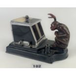 Ronson Pik-a-Cig Art Deco novelty cigarette dispenser in the form of a grabbing monkey, 9” long x 5”