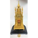 Rheims clock on 3 tier ebony base with perspex dome, marked Devaulx Paris 528, Medaille D’Or Pons