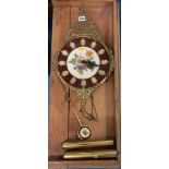 Brass and enamel floral design wall clock with pendulum and weights, 11” w x 20” h