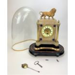 Onyx and brass clock with lion adornment on stand in glass dome. No back plate. With pendulum and