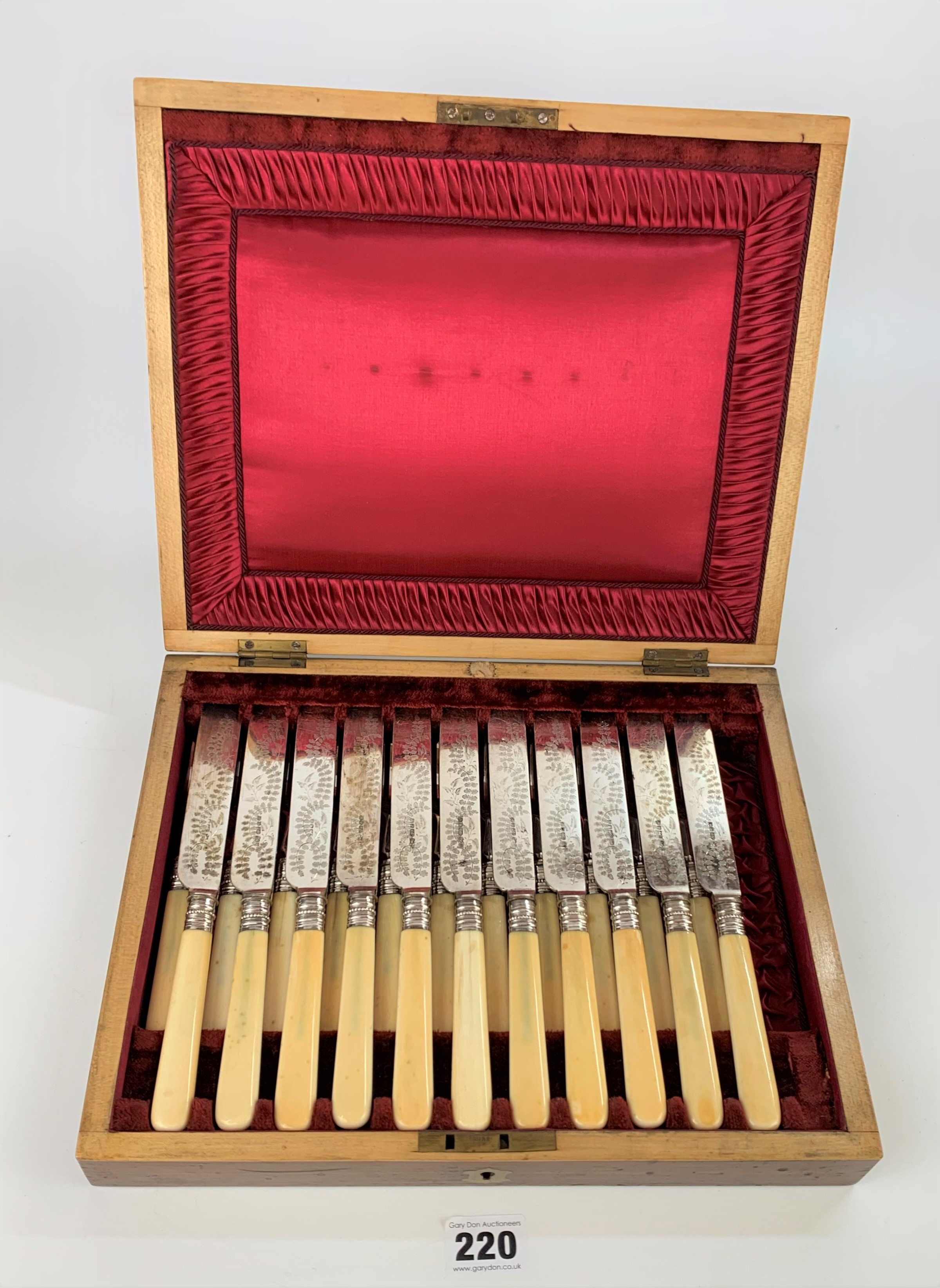 Cased canteen of 11 engraved plated and bone handled knives and 11 forks (1 knife and 1 fork