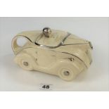 Racing car teapot in cream and gold 9”long. Some wear to gilt but no chips or cracks