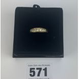 18k gold half eternity ring, centre stone not a diamond the rest are diamonds. .size Q, w: 4.3 gms