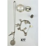 Silver jewellery including necklace with medallion, charm bracelet, napkin ring, trinket pot and