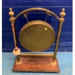 Brass dinner gong on wood base with striker, 21.5”l x 9”d x 29”h