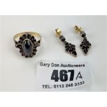 Silver gilt ring marked 900 with red garnet stones, size M, and matching pair of earrings