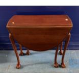 Mahogany dropleaf gateleg table with claw/ball feet and carved edges,