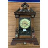 Carved mahogany wall clock with brass/enamel face with antelope design, pendulum & key,