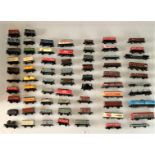 60+ assorted loose metal and plastic railway wagons and tanks