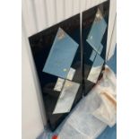 Pair of black glass surround diamond shaped mirrors, 20”w x 36”h. Some damage to edge