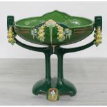 Large Eichwald Art Nouveau glazed pottery centrepiece, with moulded fruit swags and geometric
