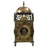 Cromwellian Eureka brass electric lantern clock, the 7" brass chapter ring enclosing a foliate